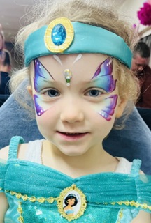 Girl with a blue butterfly face painting in Stafford